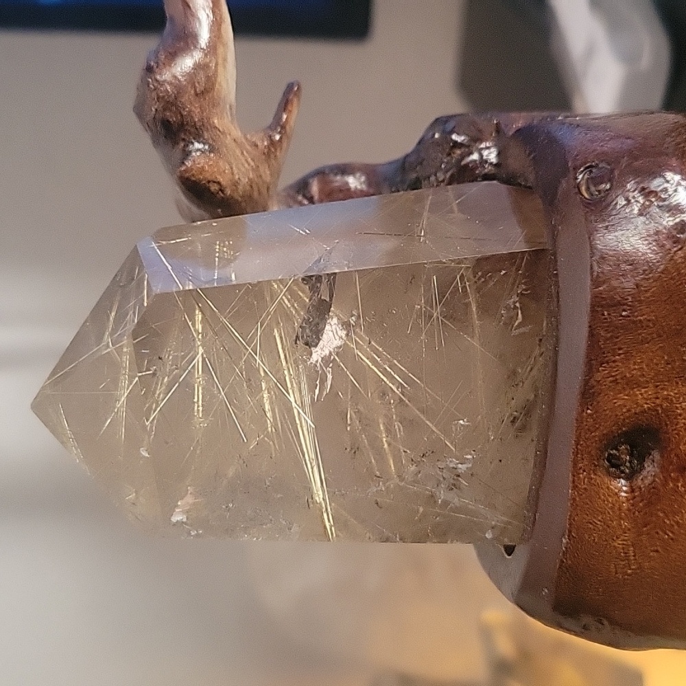 large golden rutile on stand